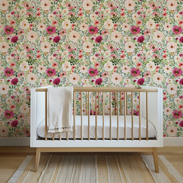 Jessica pink and red flower wallpaper behind a wood crib at 26-inch pattern scale