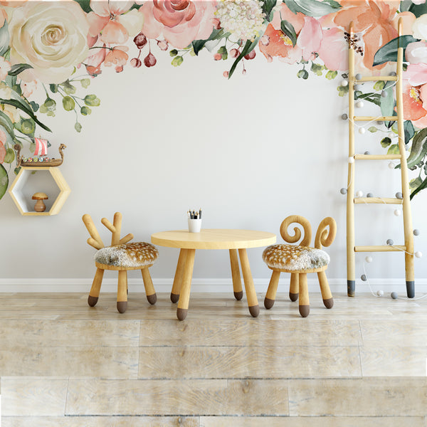 Charlotte pink and white floral arch canopy wall decal displayed behind a white nursery crib with a pink ottoman