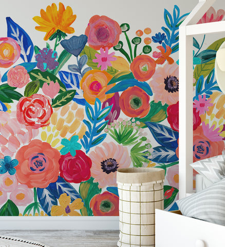 FRIDA colorful floral border wall decal with pink, red, orange and blue flowers beside a bed