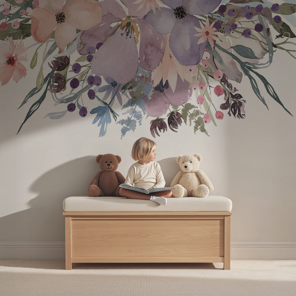 Watercolor flower wall decals above a nursery dresser with stuffed animals