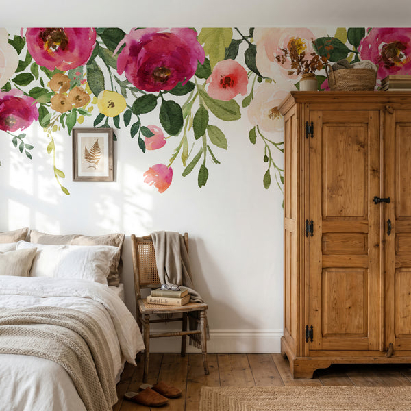 Dark pink and cream Jessica’s Farmhouse flowers trailing above a bedroom bed