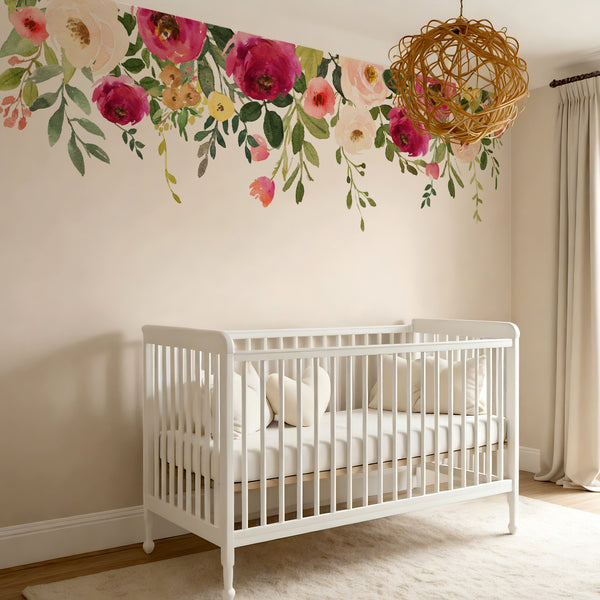 Jessica’s Farmhouse watercolor flowers arranged above a white nursery crib
