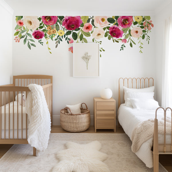 Jessica’s Farmhouse floral border wall decal above a crib and white nursery furniture