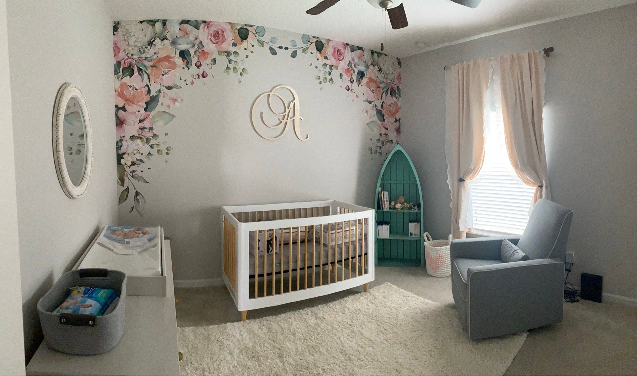Mirrored watercolor flower corners displayed across a nursery wall