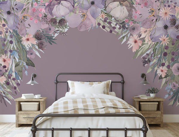 Pink and lavender floral canopy wall decal framing a dark bedroom wall above an upholstered bed