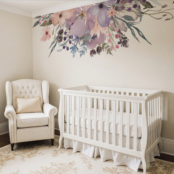 Watercolor flower border above a white crib and cream nursery chair