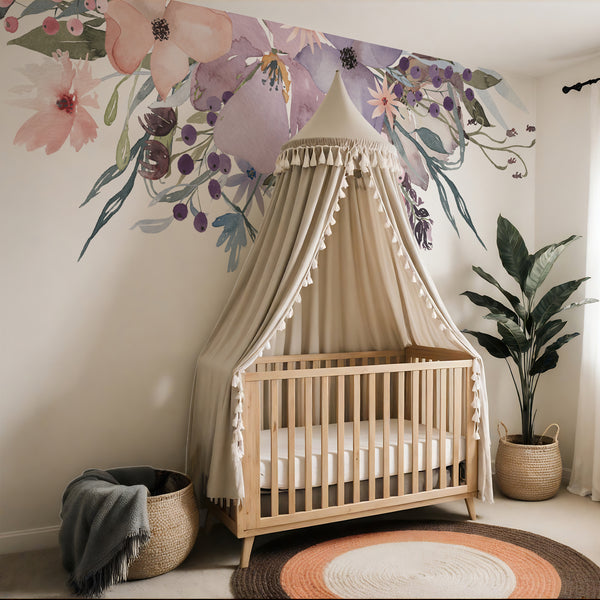 Pink and lavender floral wall decals above a hanging chair in a nursery