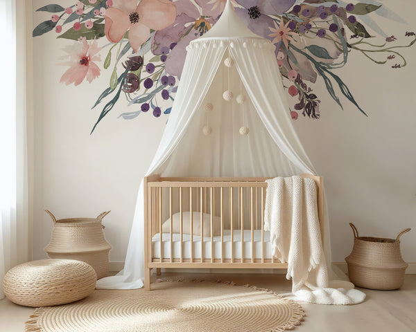Watercolor flower wall decals above a white crib and draped nursery canopy