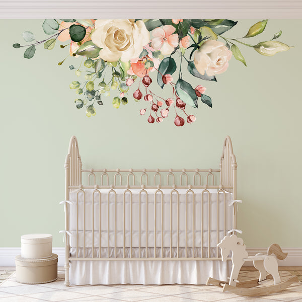 GAIA ivory and blush flowers above a light wood nursery crib
