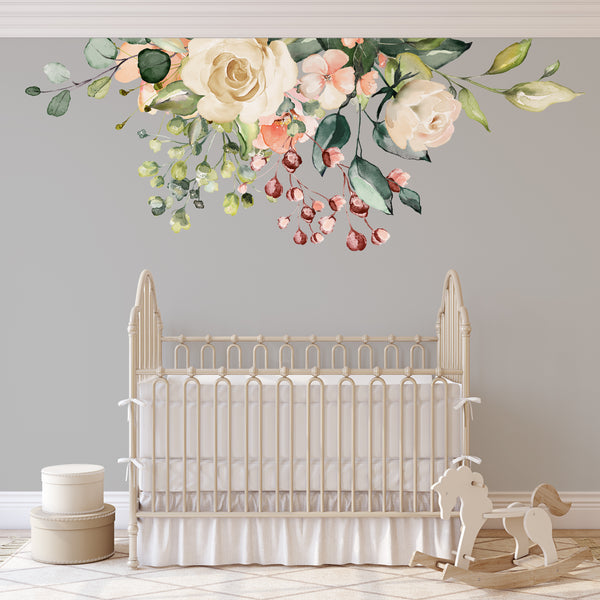 Ivory and pink GAIA flowers above a white nursery crib