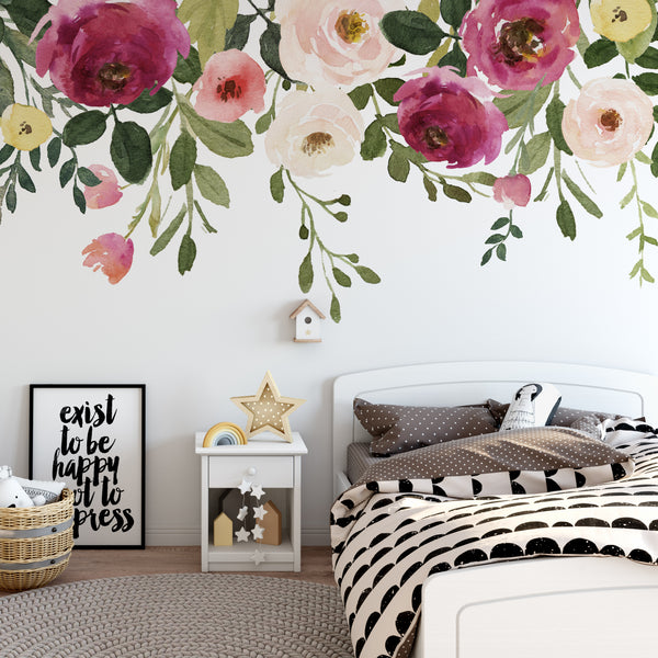 Watercolor floral border decal above a bed with black and white bedding