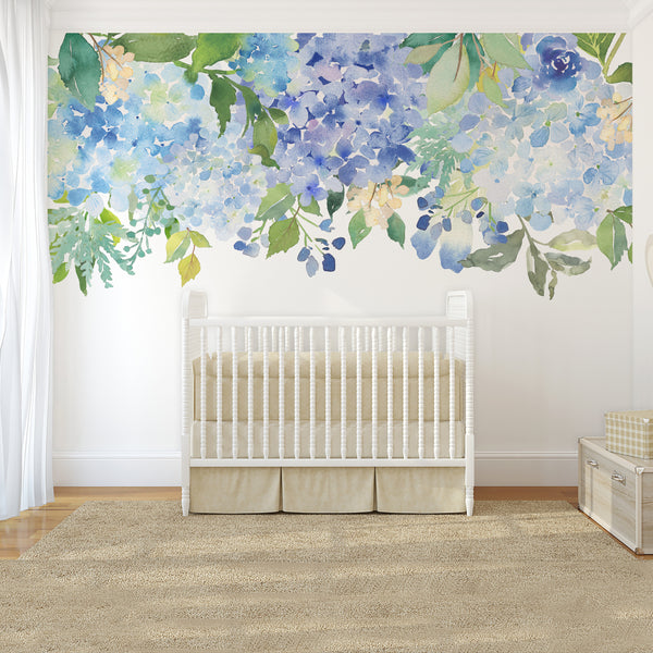 Airy blue flower border displayed above a white nursery crib
