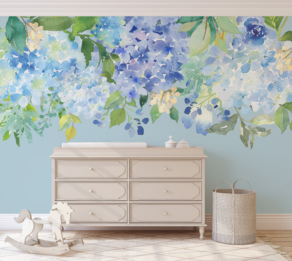 Blue and mint watercolor flowers above a white nursery dresser